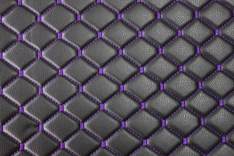 May include: Black leather upholstery with a diamond pattern stitched in purple thread.