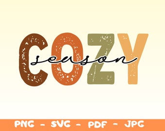 May include: A graphic design with the text "Cozy season" in a distressed font. The letters are in shades of brown, orange, and green.