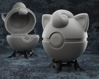 May include: Two gray and white Poke Ball figures with a black base. The Poke Balls are closed and open, revealing the inside of the ball.