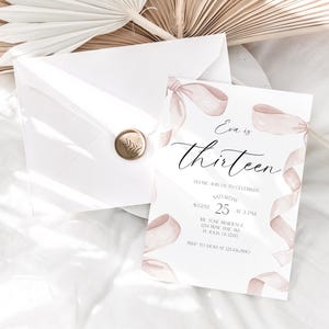 May include: A white invitation card with pink watercolour ribbons and the text "Eva is thirteen". The invitation includes the date, time, and location of the event.