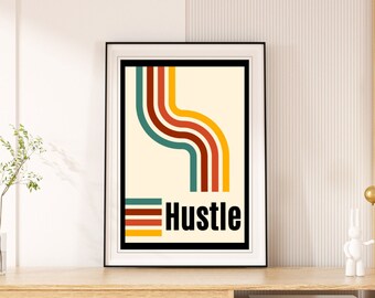 May include: A wooden TV stand with a white drawer and open shelves. A framed print with a colorful abstract design and the word "Hustle" is displayed on top of the stand.