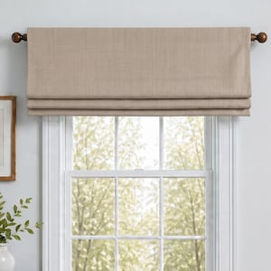 May include: A solid light brown fabric window valance hangs from a dark brown curtain rod over a white window frame. The valance features a horizontal pleated design with a smooth, woven texture, providing a clean and simple window covering.