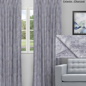 May include: Charcoal-colored Celeste curtains with a textured appearance hang in front of a window. The curtains are pleated and have a soft, flowing drape. The text "Celeste - Charcoal" is visible in the upper right corner.