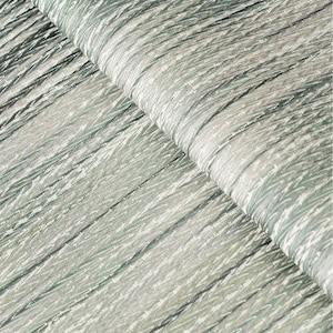 May include: Close-up of a textured fabric with a subtle green and white chevron pattern. The fabric has a soft, slightly iridescent sheen.