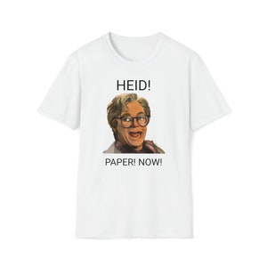 May include: White t-shirt featuring a portrait of a person wearing glasses with the text "HEID! PAPER! NOW!" in black. The portrait is a colorful illustration of a person with a surprised expression.