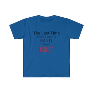 May include: Royal blue t-shirt with the text "The Last Time Someone called it a SKIRT they got KILT" in black and red. The shirt is a crew neck style.