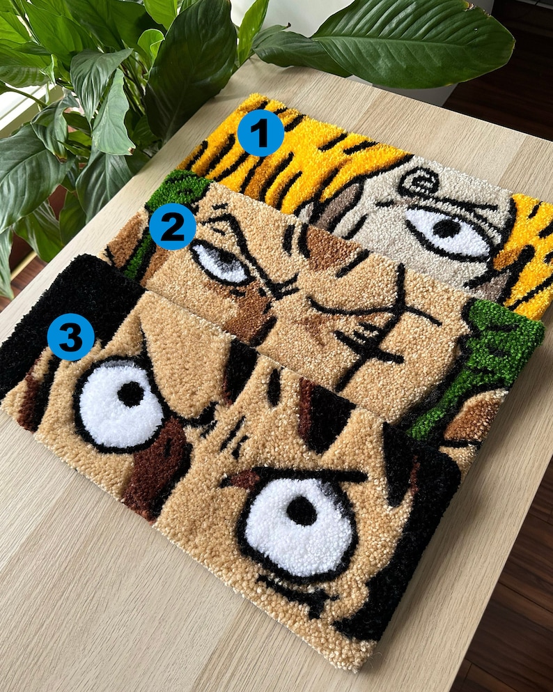 May include: Three colorful rug panels with cartoon faces. The top panel is yellow and white with a single eye. The middle panel is brown and green with a single eye. The bottom panel is brown and black with two eyes.