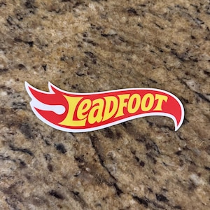 May include: A set of three ceramic mugs with a speckled, matte finish. The mugs are in shades of cream, light gray, and dark gray. Each mug has a simple, minimalist design, perfect for coffee or tea.