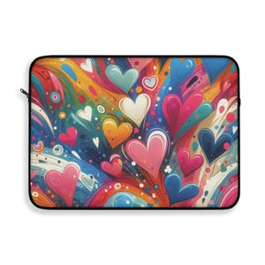 May include: Laptop sleeve featuring a vibrant, abstract design of colorful hearts in shades of pink, blue, yellow, and white against a rainbow background. The sleeve has a black zipper and trim.