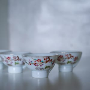 Made in vintage Japan, white porcelain Sake cups. Set of 4. Birds in sakura cherry.