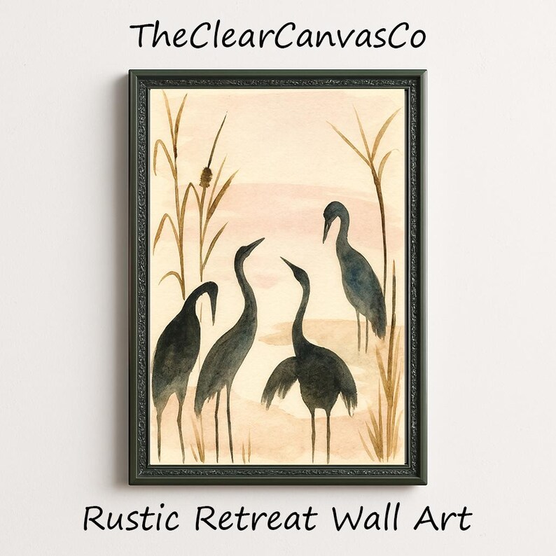 May include: A framed watercolor painting featuring four dark gray cranes in a marsh setting. The artwork has a neutral color palette with beige, brown, and pink tones. The text "TheClearCanvasCo" and "Rustic Retreat Wall Art" are visible.