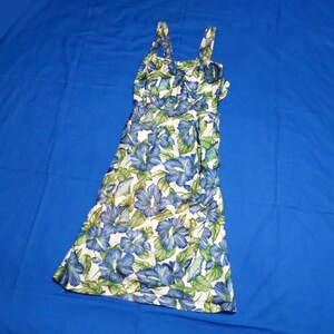 May include: A floral print dress featuring blue and green flowers on a white background. The dress has a fitted bodice, a flared skirt, and spaghetti straps. The dress is made of a lightweight fabric and is suitable for warm weather.