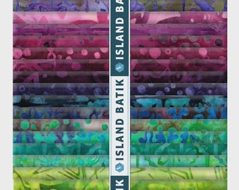 May include: A stack of fabric strips featuring a gradient of colors from green and yellow to blue, purple, and pink. Each strip displays a unique batik pattern. A vertical white band runs down the center with the text ISLAND BATIK repeated.