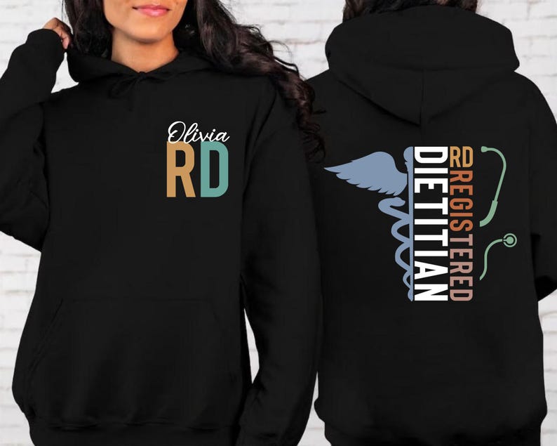 May include: Black hoodie with the text "Olivia RD" on the front, with the letters in teal and tan. The back of the hoodie features a caduceus symbol, a stethoscope, and the words "RD REGISTERED DIETITIAN".