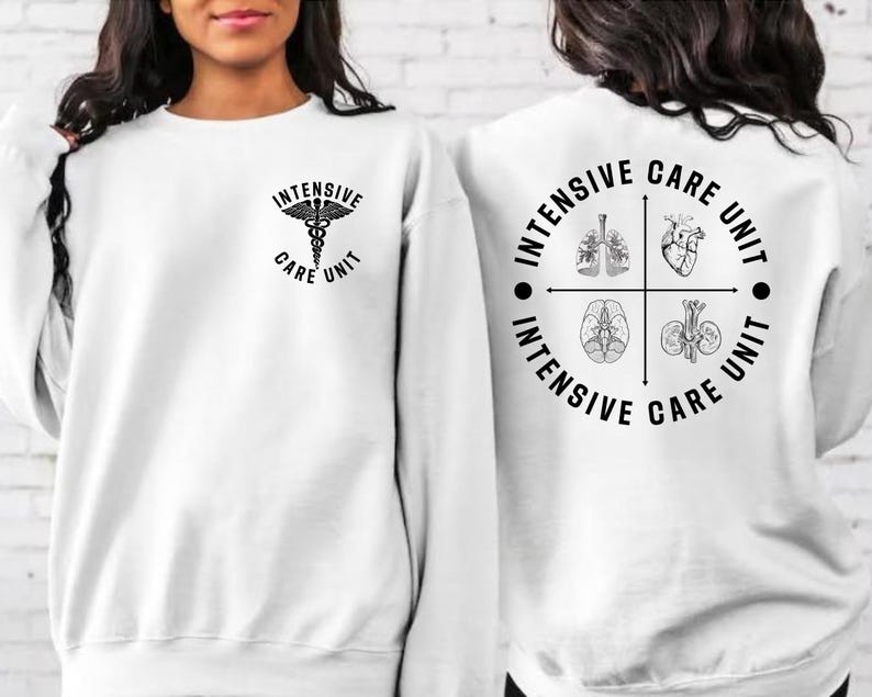 May include: White sweatshirt with black text and graphics. The front features a medical symbol and the words "Intensive Care Unit." The back displays a circular design with the words "Intensive Care Unit" and illustrations of internal organs.