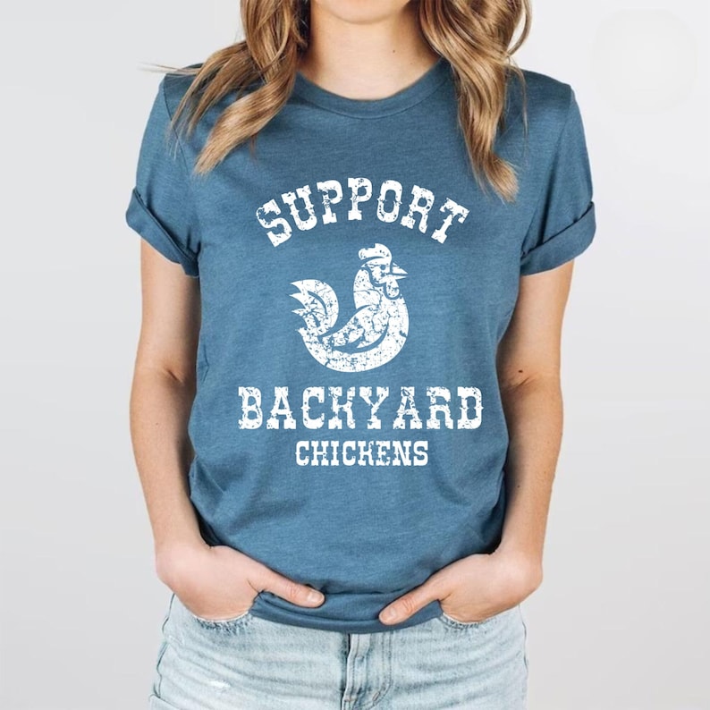 May include: A blue t-shirt with a white distressed graphic of a chicken and the text "Support Backyard Chickens".