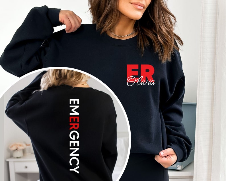 May include: Black sweatshirt with white text "EMERGENCY" down the back and red text "ER Olivia" on the front.