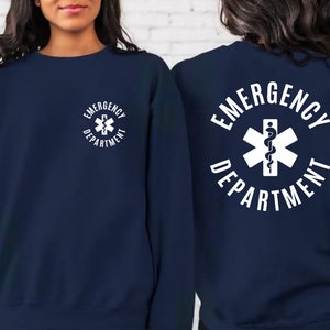 May include: Navy blue sweatshirt with white text that reads "Emergency Department" and a white medical symbol with a snake.