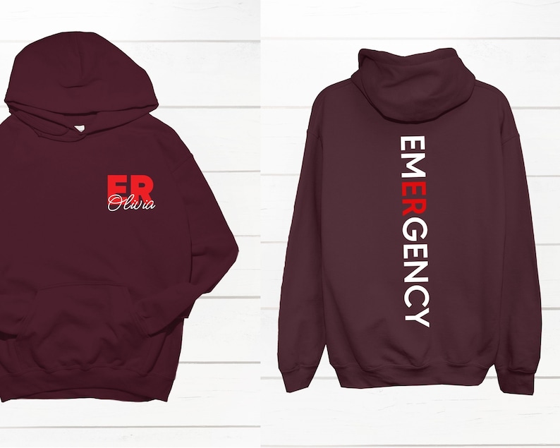 May include: Burgundy hoodie with a white and red "EMERGENCY" graphic on the back and a red "ER" graphic with the name "Olivia" on the front.