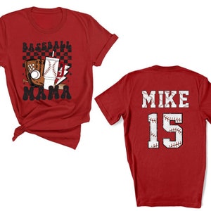 May include: Red baseball-themed t-shirts. One shirt features a baseball glove, baseball, drink, and the text "Baseball Mama". The other shirt displays "MIKE 15" in a baseball font.