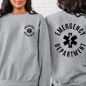 May include: Gray sweatshirt with the text "EMERGENCY DEPARTMENT" and a medical symbol on the back. The same text and symbol are on the front in a smaller size.