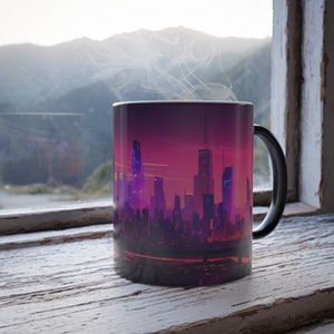 May include: A black ceramic mug with a cityscape design. The mug features a purple and pink sunset over a city skyline with tall buildings. Steam is rising from the mug, suggesting it is filled with a hot beverage.
