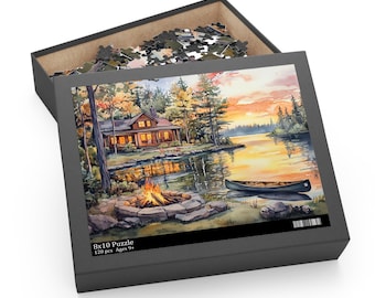 May include: A 120-piece jigsaw puzzle depicting a cabin in the woods by a lake at sunset. The cabin has a porch with chairs and a fire pit in front of it. A canoe is in the water. The puzzle box is black with the text "8x10 Puzzle 120 pcs Ages 9+"