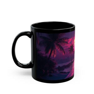 May include: Black ceramic mug with a colorful sunset scene featuring palm trees and a beach. The scene is in shades of pink, purple, and blue.