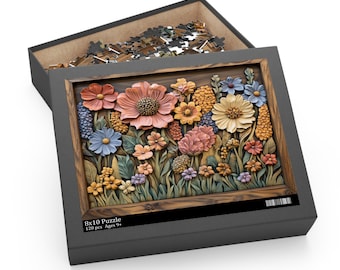 May include: A floral-themed puzzle in a gray box. The puzzle features a detailed, three-dimensional design of colorful flowers in shades of pink, yellow, blue, and orange. The box is labeled "8x10 Puzzle" and "120 pcs Ages 9+".