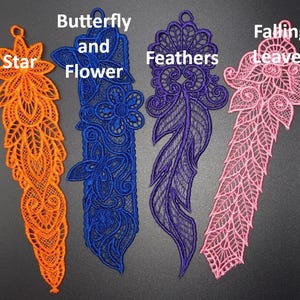 May include: Four embroidered bookmarks in orange, blue, purple, and pink. The bookmarks feature intricate designs, including a star, butterfly and flower, feathers, and falling leaves. Each bookmark has a loop at the top for easy use.