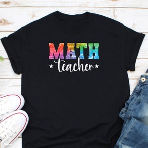 May include: Black t-shirt with a rainbow-colored "MATH teacher" graphic.