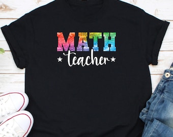 May include: Black t-shirt with a rainbow-colored "MATH teacher" graphic.