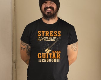 May include: A black t-shirt with a graphic of a bass guitar and the text "Stress in caused by not playing bass guitar enough".