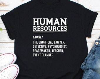 May include: Black t-shirt with white text that reads "HUMAN RESOURCES (NOUN) THE UNOFFICIAL LAWYER, DETECTIVE, PSYCHOLOGIST, PEACEMAKER, TEACHER, EVENT PLANNER."