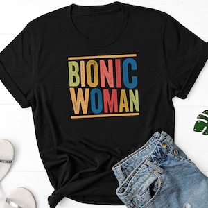 May include: Black t-shirt with the text "Bionic Woman" in colourful retro lettering.