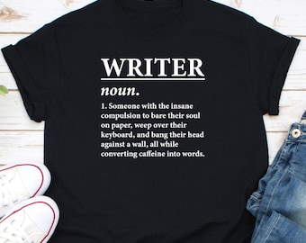 May include: Black t-shirt with white text that reads "WRITER noun. 1. Someone with the insane compulsion to bare their soul on paper, weep over their keyboard, and bang their head against a wall, all while converting caffeine into words."