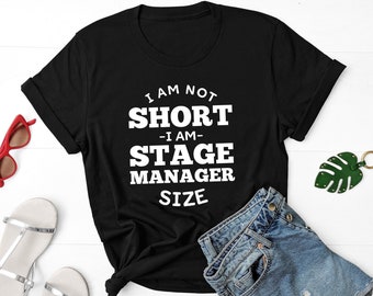 May include: Black t-shirt with white text that reads "I am not short - I am - Stage Manager Size".