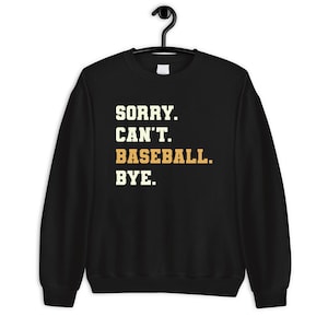 May include: Black sweatshirt with the text "SORRY. CAN'T. BASEBALL. BYE." in white and orange.