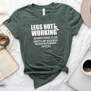 May include: A dark green t-shirt with white text that reads "Legs Not Working (Everything Else Meets or Exceeds Manufacturers Specs.)".