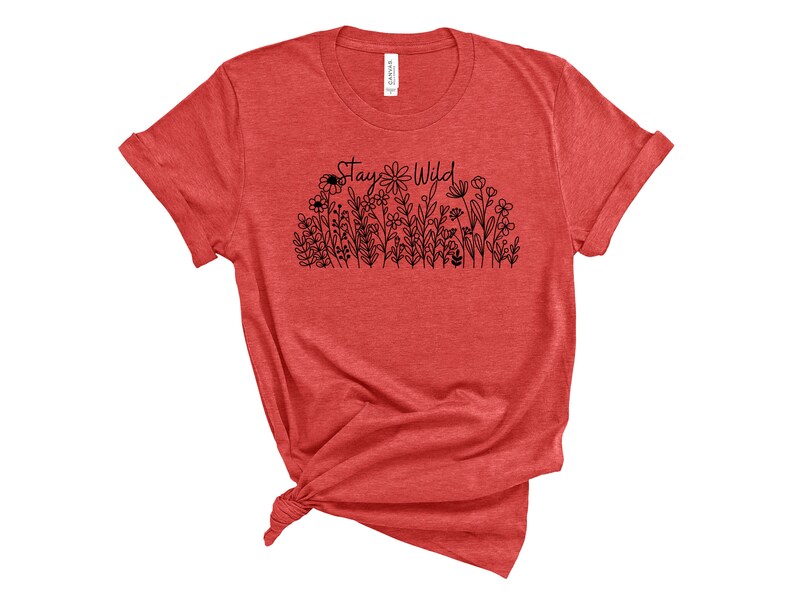 May include: Red t-shirt with a black graphic that says "Stay Wild" and features a line of flowers and a bee.