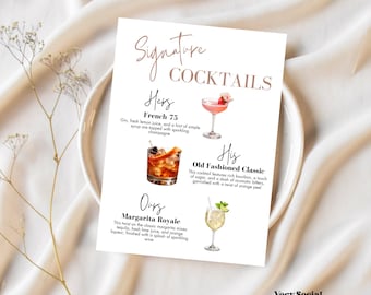 May include: A white rectangular sign with the words "Signature Cocktails" and three cocktail illustrations. The sign includes the names and ingredients of each cocktail: French 75, Old Fashioned Classic, and Margarita Royale. The sign is on a white plate.