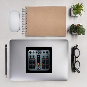 May include: A sticker featuring a detailed, gray control panel with various buttons, switches, and lights. The sticker is on a laptop, surrounded by a white mouse, a spiral-bound notebook, a pencil, glasses, and small potted plants.
