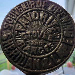 May include: A cast iron souvenir of the Grand River, Michigan. The text reads "Souvenir of Grand River, Michigan".