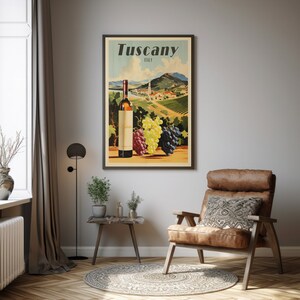 May include: Vintage travel poster for Tuscany, Italy, featuring a bottle of wine and grapes against a backdrop of rolling hills and vineyards. The poster has a retro, mid-century modern aesthetic.