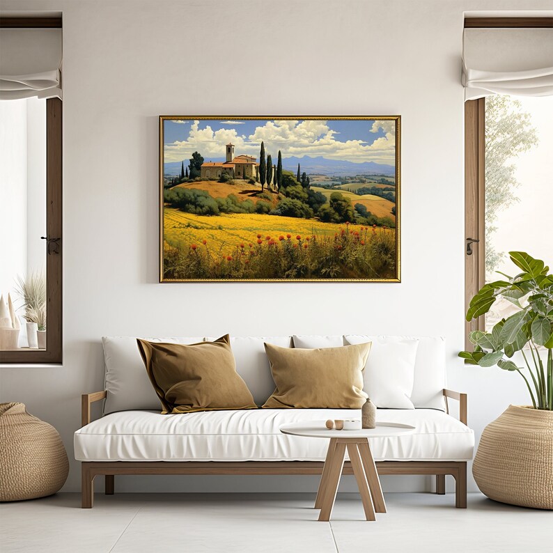 K&ouml;nnte beinhalten: Ein gerahmtes Gem&auml;lde einer Landschaft mit einer kleinen Kirche, gr&uuml;nen B&auml;umen und einem Feld mit gelben Blumen. Das Gem&auml;lde ist vor einem blauen Himmel mit wei&szlig;en Wolken platziert.