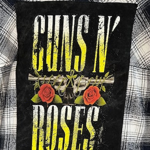 May include: Black and yellow Guns N' Roses patch with a distressed look. The patch features two red roses and a pair of crossed pistols.