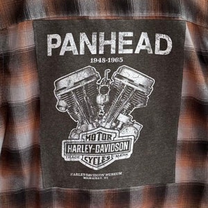 May include: A gray and black patch with the text "PANHEAD 1948-1965" and a black and white illustration of a Harley-Davidson motorcycle engine. The text "MOTOR HARLEY-DAVIDSON TRADE CYCLES MARK" is below the illustration. The text "HARLEY-DAVIDSON MUSEUM MILWAUKEE, WI" is at the bottom of the patch.