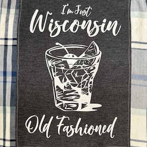May include: A gray patch with white text that reads "I'm Just Wisconsin Old Fashioned". The patch features a white illustration of an old fashioned cocktail with a cherry and a lime wedge.