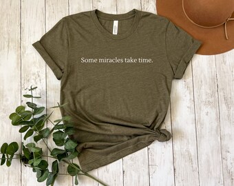 Some Miracles Take Time Shirt on Heather Green. IVF T-Shirt. IUI Shirt. Fertility shirt. Shirt for Hope. Gift for friend. Gift for wife