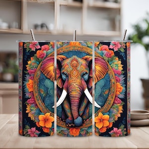 Puede incluir: Tres vasos de acero inoxidable coloridos con un diseño de mandala que presenta un elefante con detalles intrincados. El elefante está rodeado de flores y hojas en tonos de azul, verde, naranja y rosa.